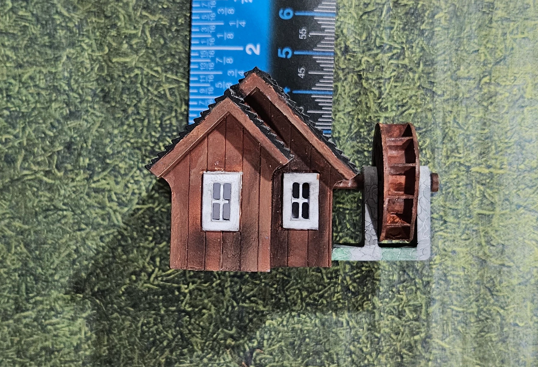 Height reference view of HO scale waterwheel with small building